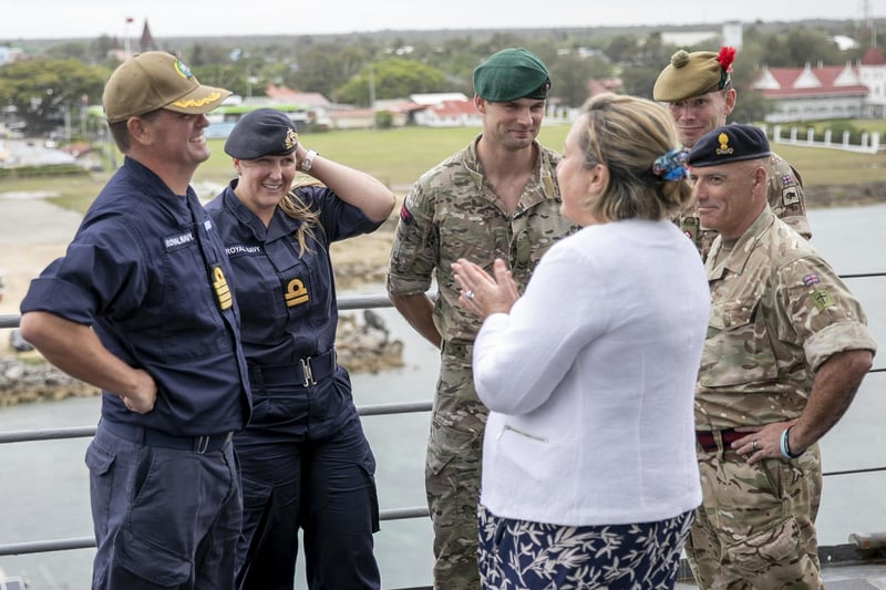 NUKU’ALOFA, Tonga (Nov. 14, 2023) – Anne-Marie Trevelyan, UK Minister of State for Indo-Pacific, center, speaks with Royal Navy Capt. Joseph Dransfield, Pacific Partnership 2023 deputy mission commander, left, and other British armed forces service members after a tour of Harpers Ferry-class amphibious dock landing ship USS Pearl Harbor (LSD 52) and Pacific Partnership 2023 brief, Nov. 14.