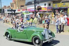 Mayor and Mayoress of Skegness Couns Ady Findley and Sarah Staples wave to the crowd in the classic car Peanut.