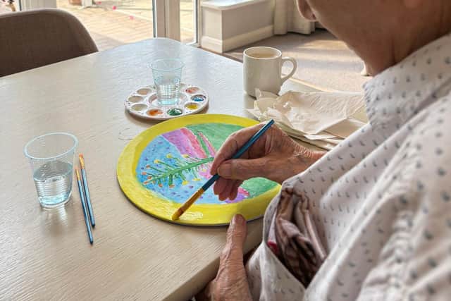Resident Eric Limb painting at HC-One’s Elmwood House Care Home