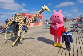 Sebastian Mayer and his life-size giraffe puppet Zarafa on Skegness Pier.