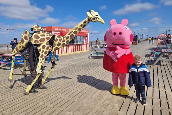 Sebastian Mayer and his life-size giraffe puppet Zarafa on Skegness Pier.