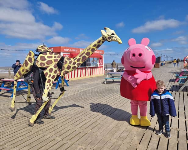 Sebastian Mayer and his life-size giraffe puppet Zarafa on Skegness Pier.
