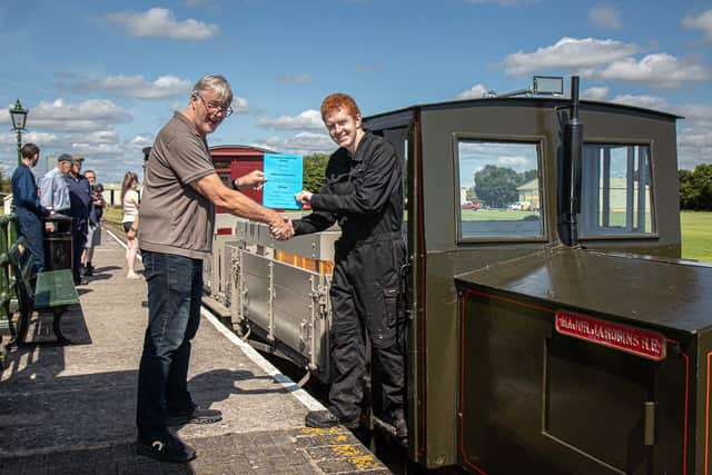 LCLR Company Secretary John Chappell (left) presents Matthew Forman-Clark with his driver’s certificate at Walls Lane station in theSkegness Water Leisure Park. (Photo: LCLR/Dave Enefer).