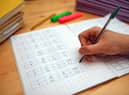 File photo dated 05/03/2017 of a primary school teacher marking a pupil's maths homework. Children in the "best-off" homes were more likely to report having had private tutoring than their peers in the "worst-off" homes (35% compared with 21%), according to the Sutton Trust report. A survey of 2,394 schoolchildren aged 11 to 16 in England and Wales found that 30% said they have had private tuition, up from 27% pre-pandemic. The proportion is the joint highest figure since the survey began in 2005, when it stood at 18%. Issue date: Thursday March 9, 2023.