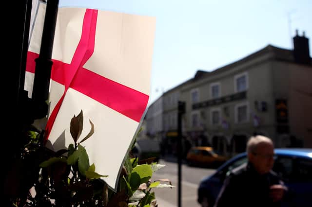 A member of the public walks past a St George's flag in Warminister in Wiltshire as the town celebrates St George's Day.
