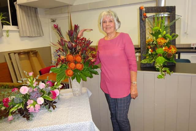 Jenny Kirkby pictured with autumn flower arrangements demonstrated at Spilsby and district Flower Club