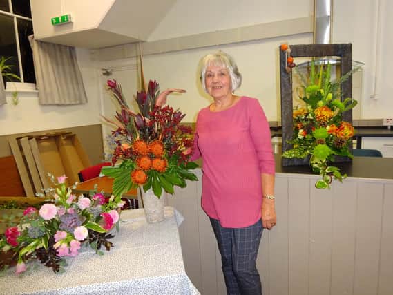 Jenny Kirkby pictured with autumn flower arrangements demonstrated at Spilsby  and district Flower Club