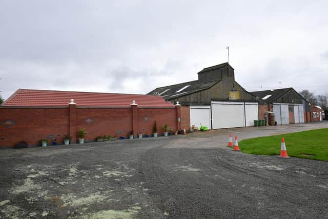 The exterior of the site, past large metal gates.