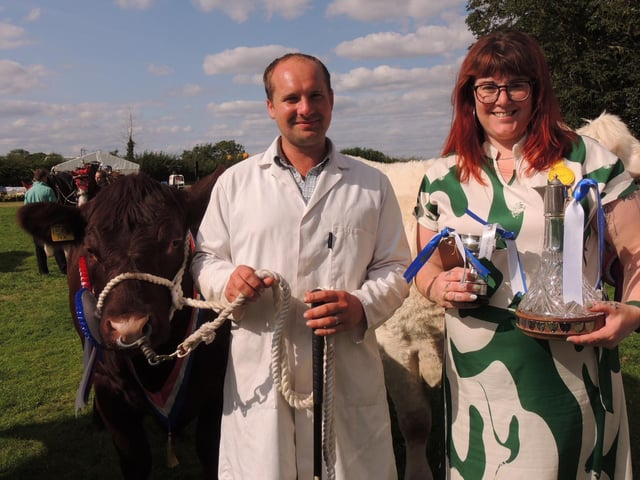 Barry Holden of Spilsby with Charlotte Dennis of Duncan and Toplis and his breed champion and reserve supreme champion and junior champion Lincoln Red.