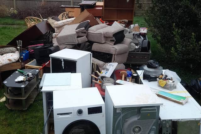 The wrecked furniture from four downstairs rooms was left outside for a month. Photo supplied