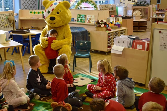 Pudsey bear hugs a pupil at Carlton Road Academy.