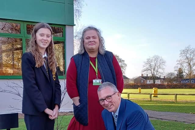 Banovallum headteacher Grant Edgar, Chair of Governors Wendy Ireland, and Isobel Gosling plant the time capsule.