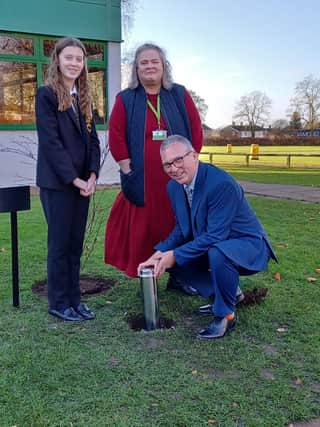 Banovallum headteacher Grant Edgar, Chair of Governors Wendy Ireland, and Isobel Gosling plant the time capsule.