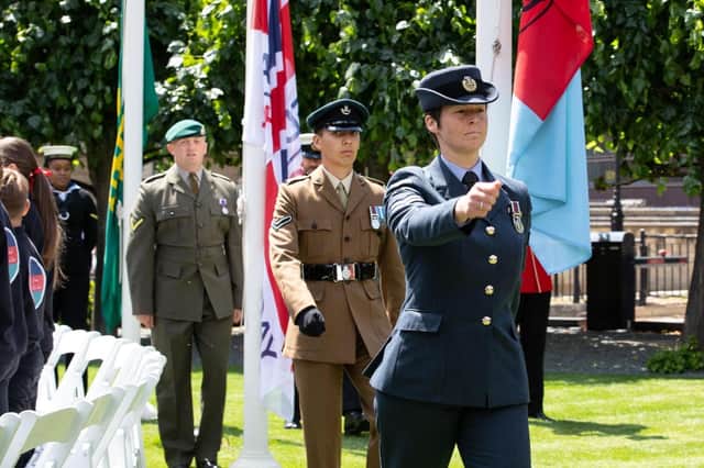 Dianne Smith (in the blue uniform) at the flag raising ceremony. Photo: Sgt Jimmy Wise RAF – UK MOD © Crown copyright 2022.