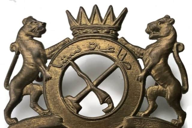 Bruce co-designed the regiment's crest, with fighting tigers and motto in Jawi script.