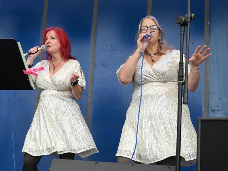 Whiskey Rose performing on stage at the village cross.