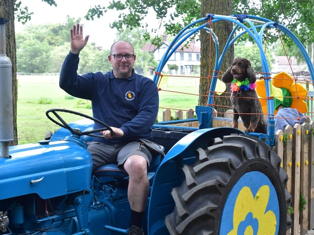A cheery wave from this driver, who took part in the ever-popular Wolds Tractor Run with his faithful friend.