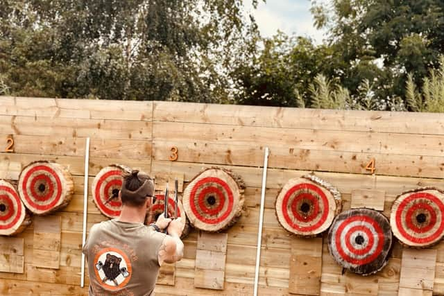 Spencer demonstrates knife throwing.