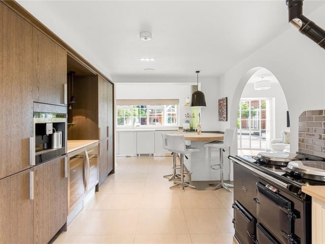 The kitchen with summer room through the arch.