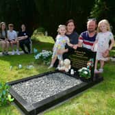 Hayley and Stephen Ormond with their children, from left: Nicole, Zack, Jessica, Lucy, and Isla Ormond. Pictured in Louth Cemetery where their stillbirth babies are buried. Photos: D.R.Dawson Photography