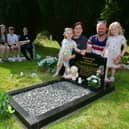 Hayley and Stephen Ormond with their children, from left: Nicole, Zack, Jessica, Lucy, and Isla Ormond. Pictured in Louth Cemetery where their stillbirth babies are buried. Photos: D.R.Dawson Photography
