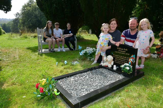 Hayley and Stephen Ormond with their children, from left: Nicole, Zack, Jessica, Lucy, and Isla Ormond. Pictured in Louth Cemetery where their stillbirth babies are buried. Photos: D.R.Dawson Photography