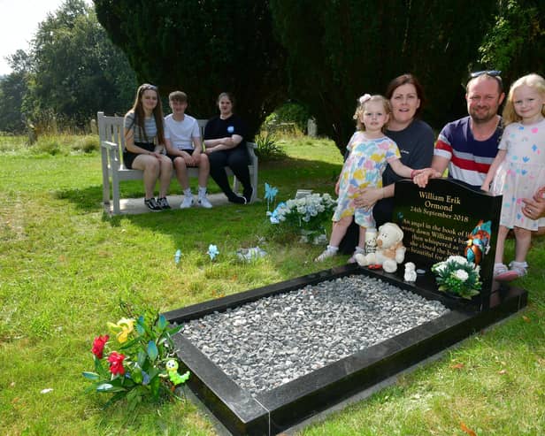 Hayley and Stephen Ormond with their children, from left: Nicole, Zack, Jessica, Lucy, and Isla Ormond. Pictured in Louth Cemetery where their stillbirth babies are buried. Photos: D.R.Dawson Photography