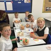 Grimoldby pupils decorating their terracotta candle holders.