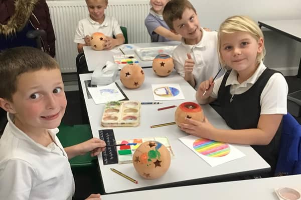 Grimoldby pupils decorating their terracotta candle holders.