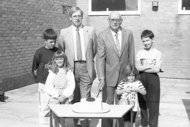Former headmaster John Ball cuts the school's 25th birthday cake, watched by children and Roy Pearson, the head at the time.