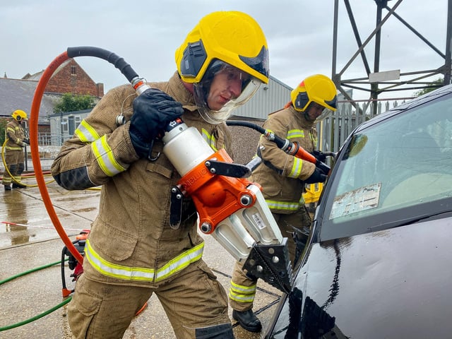 Firefighters Dean McNaughton and Chantelle Goodwin demonstrate the 'Jaw's of Life' on a car wreck.