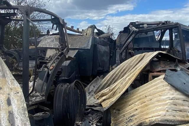 Burnt out farm vehicles at the site.