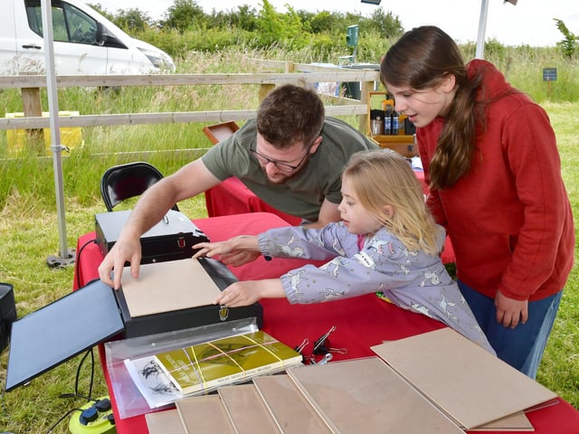 Kieran Hill of Electric Egg, with Harriet Eaves 6 and Tilda Hatton 11, making Cyanotypes, an early form of victorian photography