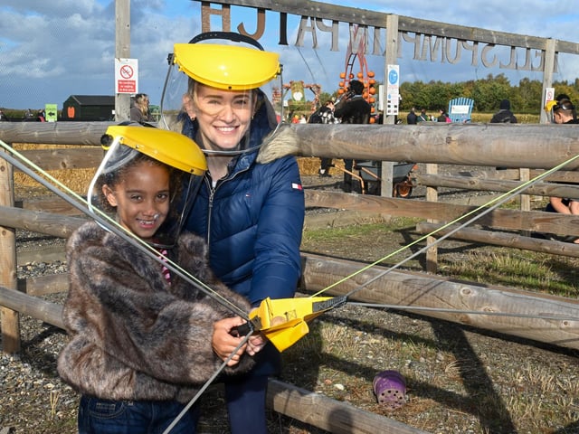 Shannon Houghton, of Pinchbeck, with her goddaughter, Mila Thorpe-Santos, seven, on the potato catapult.