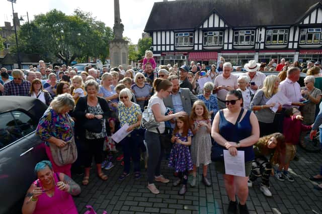 Crowds gather to hear the proclamation by John Griffiths, Sleaford Town Crier in Sleaford Market Place.