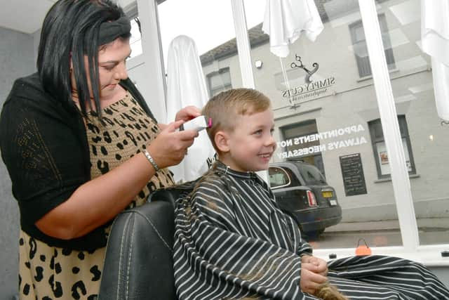 Simply Cuts owner, Rachel Gay cutting AJ's hair.