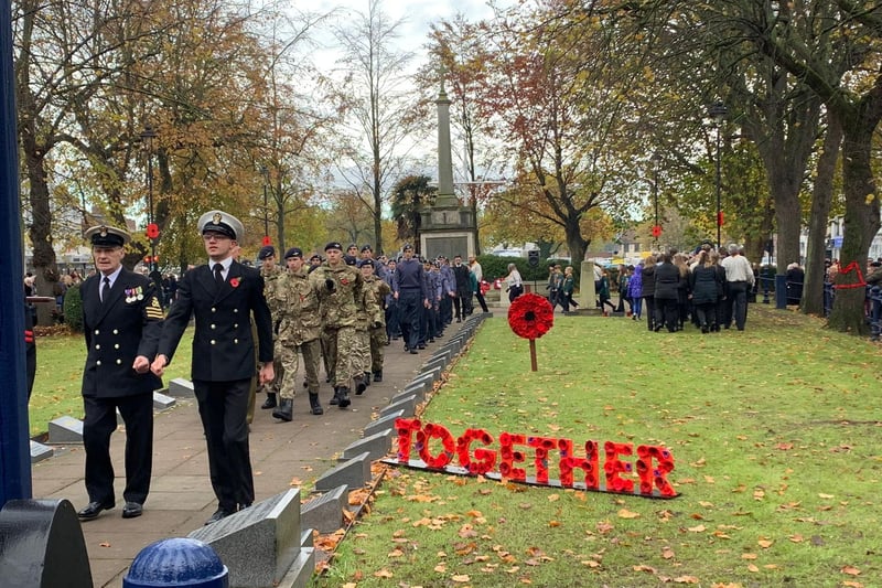 Armed forces personnel march at Boston Memorial Gardens.