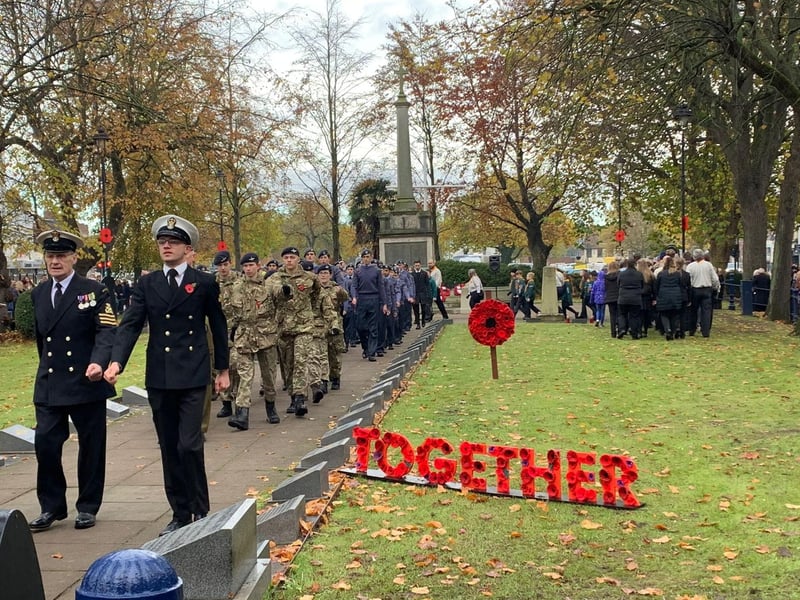 Armed forces personnel march at Boston Memorial Gardens.