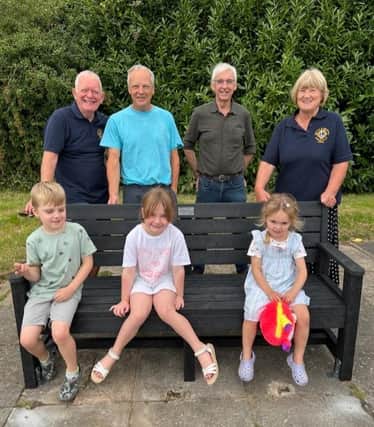 Pictured at the new bench, from left: Lions president Andrew MacKenzie , Lion Pete Wilson, Lion Malcolm Lamb and Lion Jayne Jacklin with local children.