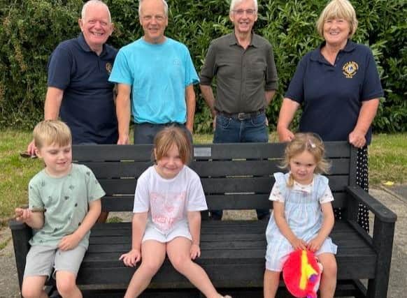 Pictured at the new bench, from left: Lions president Andrew MacKenzie , Lion Pete Wilson, Lion Malcolm Lamb and Lion Jayne Jacklin with local children.