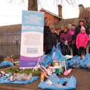 ​Volunteers show off their bags of litter and recycling. Photo: AH