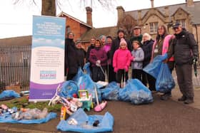 ​Volunteers show off their bags of litter and recycling. Photo: AH