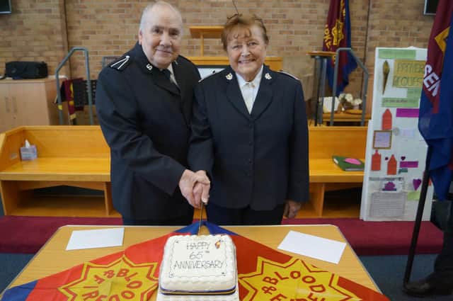 Pat and John Barrett cutting their anniversary cake