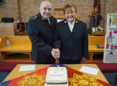 Pat and John Barrett cutting their anniversary cake