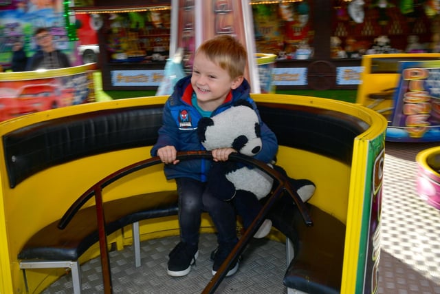 Logan Newby, aged four, of Boston, rides on the teacups.