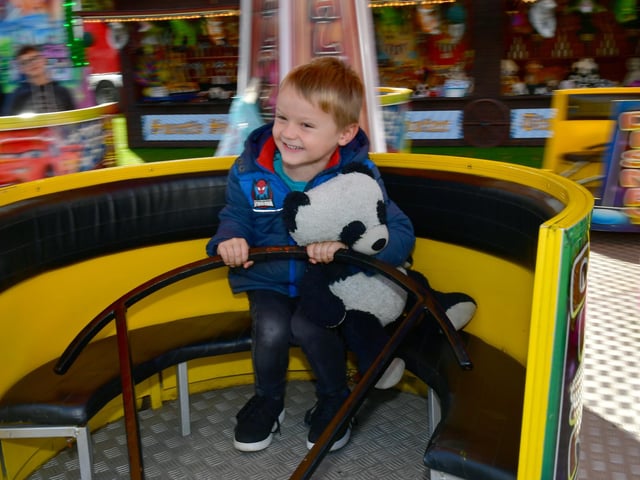 Logan Newby, aged four, of Boston, rides on the teacups.