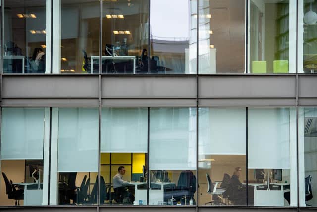 Office workers in Manchester sit amongst empty chairs, the day after Prime Minister Boris Johnson called on people to stay away from pubs, clubs and theatres, work from home if possible and avoid all non-essential contacts and travel in order to reduce the impact of the coronavirus pandemic.