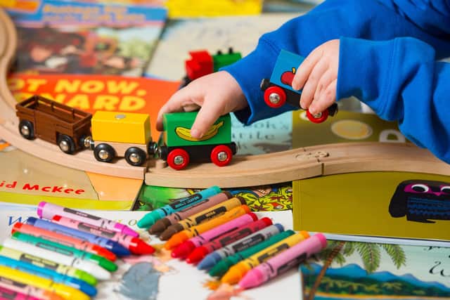 Generic stock photo shows a toddler playing with a selection of children's toys, including wooden building blocks, crayons and a train set. PRESS ASSOCIATION Photo. Picture date: Tuesday January 27, 2015. Photo credit should read: Dominic Lipinski/PA Wire