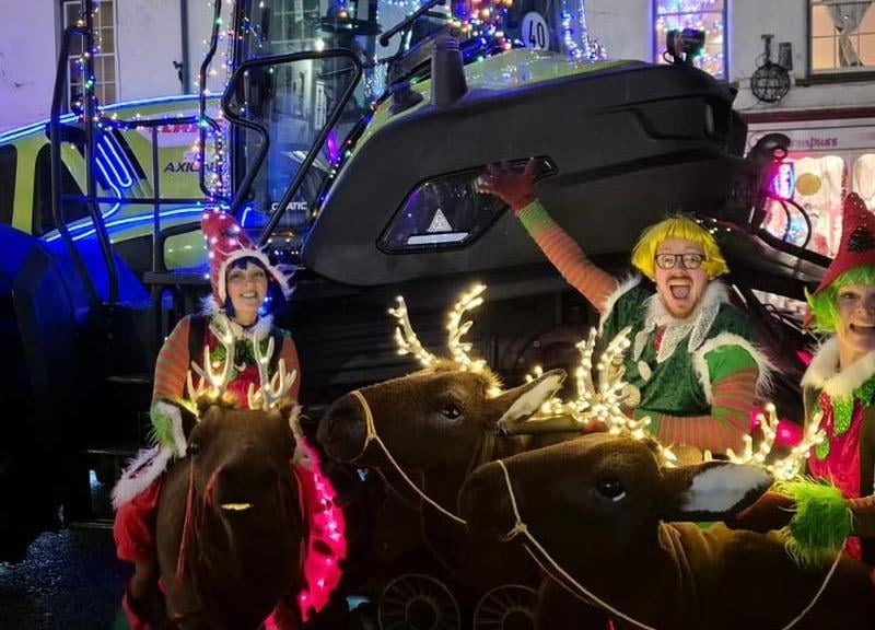 Rhubarb Theatre performers beside one of the tractors in the Santa parade. Photo: Alford Town Promotions
