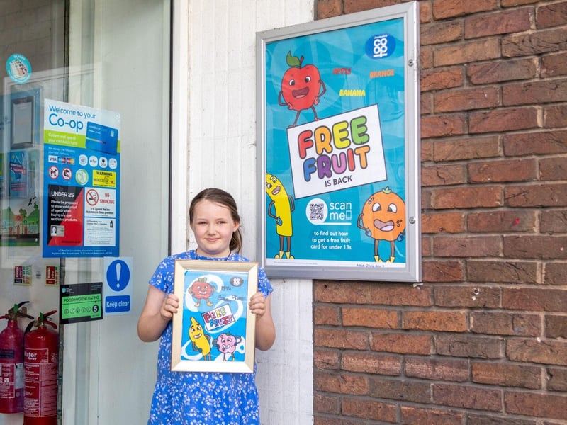 Olivia with her original artwork, next to a poster outside Horncastle Food Store